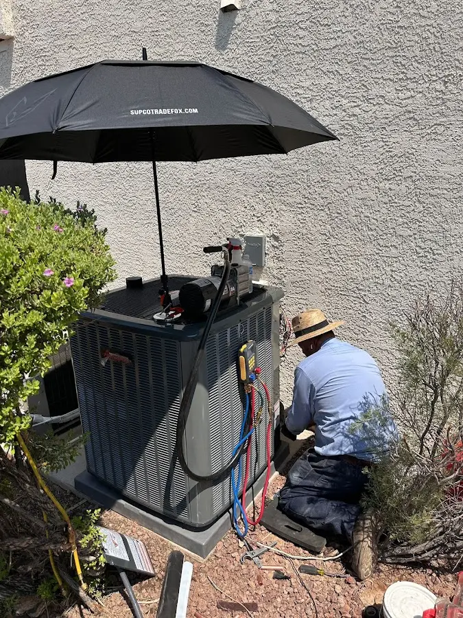HVAC technician performing outdoor AC maintenance in Alliance